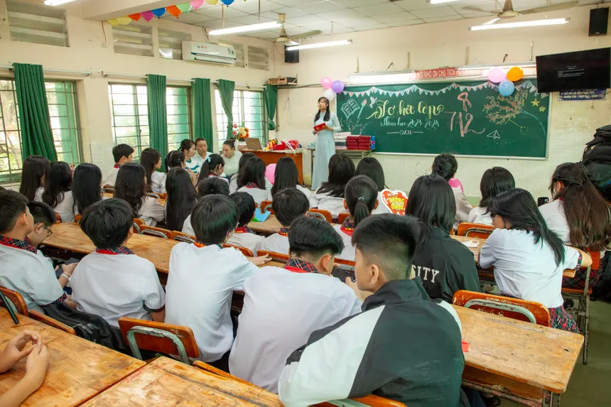 Students attentively listen to a teacher in a vibrant classroom setting, promoting education.