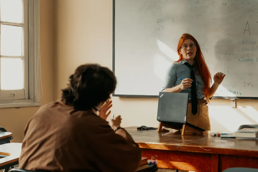 Teacher engages with student during a lesson at a Buenos Aires university classroom.